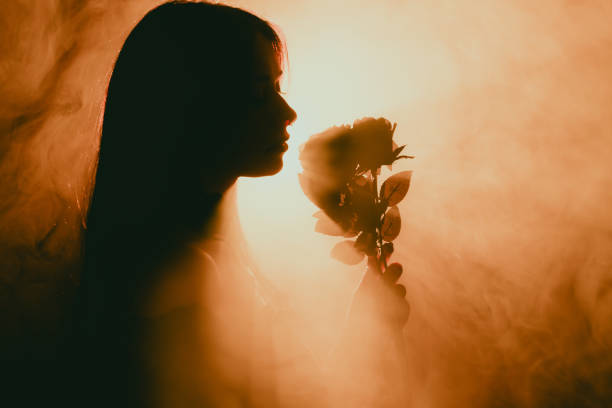 Young Female Gothic Model Posing in Studio With Black Outfit and Roses, Soft, Hazy, and Foggy ambience in low light environment