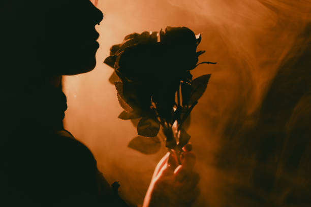 istock Young Female Gothic Model Posing in Studio With Black Outfit and Roses 2191515561