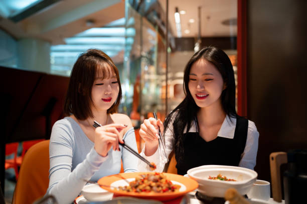 istock Asian young women eating dinner in Chinese restaurant 2191516090