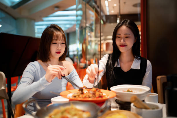 istock Asian young women eating dinner in Chinese restaurant 2191516094