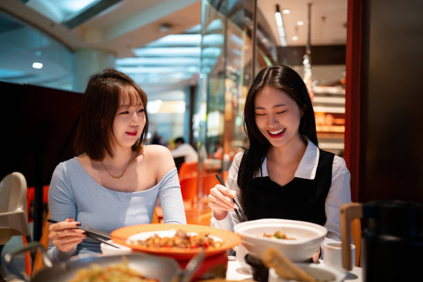 istock Asian young women eating dinner in Chinese restaurant 2191516097