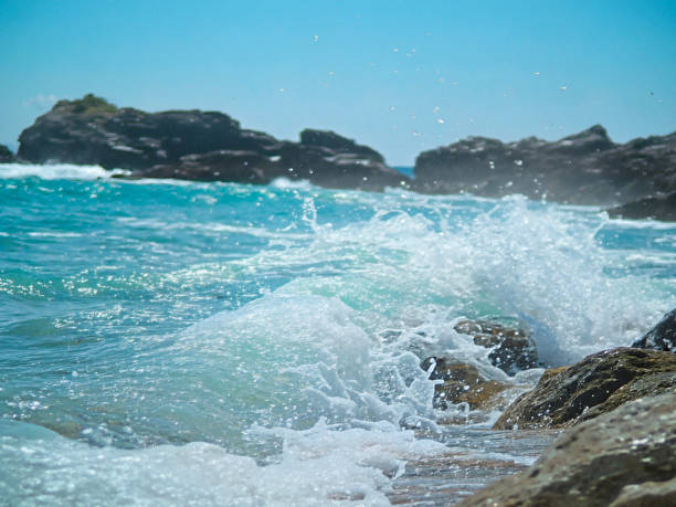 istock waves crashing against the rocks on the shore. 2191520506