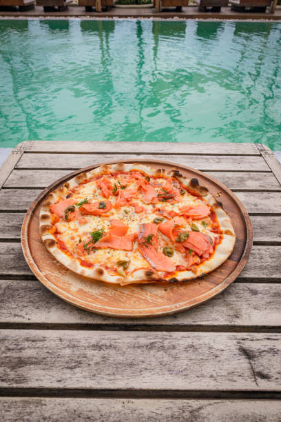 istock Pizza with salmon place on wooden tray 2191525154