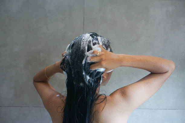 istock woman washing hair with shampoo back view 2191526004