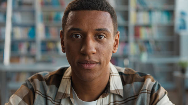 istock African American man ethnic male guy student learner university library college high school looking at camera study learning educated face academy graduate intelligence lesson clever campus bookworm 2191528059
