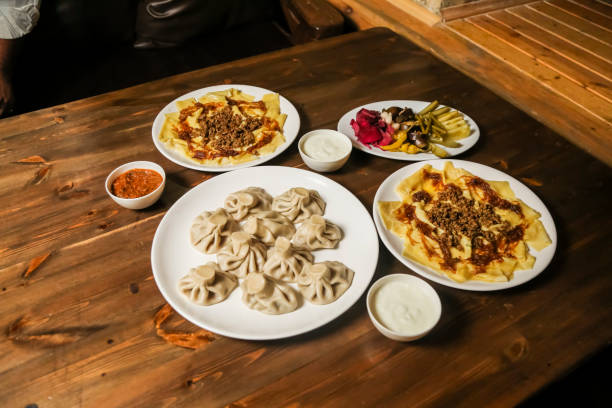 istock Flavorful spread of dumplings and appetizers on a rustic wooden table 2191528748