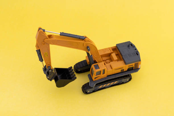 istock High angle view of a toy excavator on yellow background 2191530405