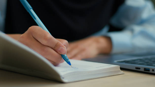 istock Cropped shot female hands student study use laptop write in notebook exam online education unknown muslim woman businesswoman girl employer worker writing notes business tasks schedule on table desk 2191530461