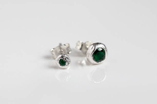istock Pair of elegant handmade round silver stud earrings with green gemstones on white background. 2191531002