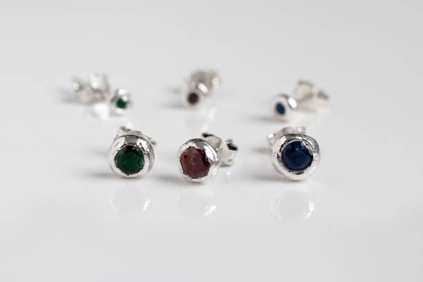 istock Sterling silver stud earrings with round gemstones isolated on white background. Handmade jewelry. 2191531006