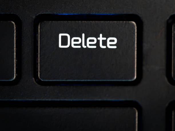 A close-up of a Delete key on a laptop keyboard
