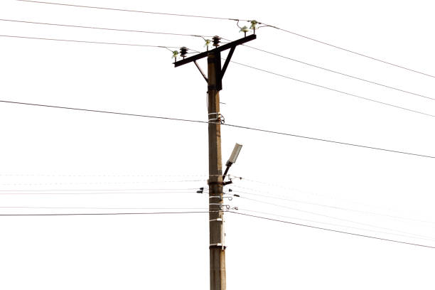 A tall pole with many wires coming out of it. The pole is surrounded by a white background