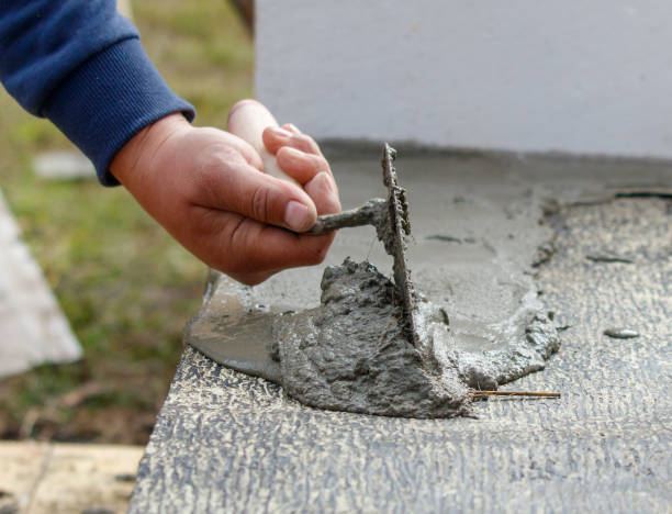 istock A person is using a trowel to spread concrete on a surface 2191534342