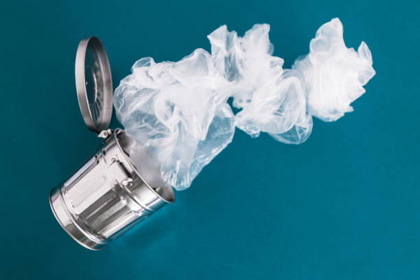 istock recycling and avoiding landfill, open trash can with single use plastic bags flying into ot out of it 2191536569