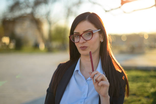 istock Confident Woman with Glasses Posing Outdoors in Professional Attire 2191537811