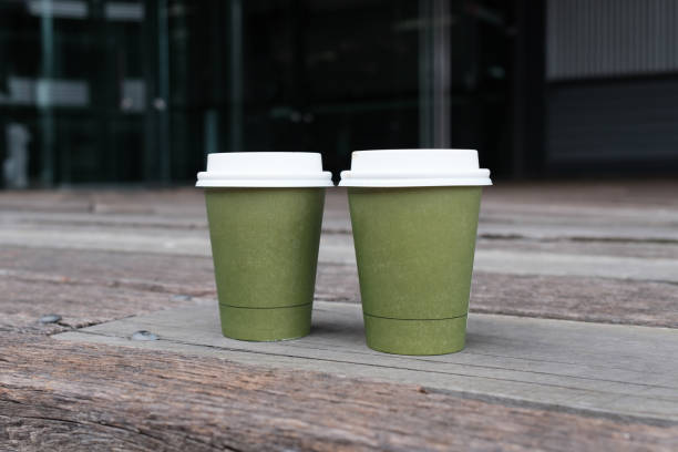 Two take away coffee cups on wooden surface