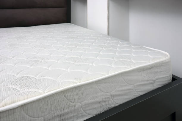 istock New white mattress on grey bed indoors, top view. 2191539453