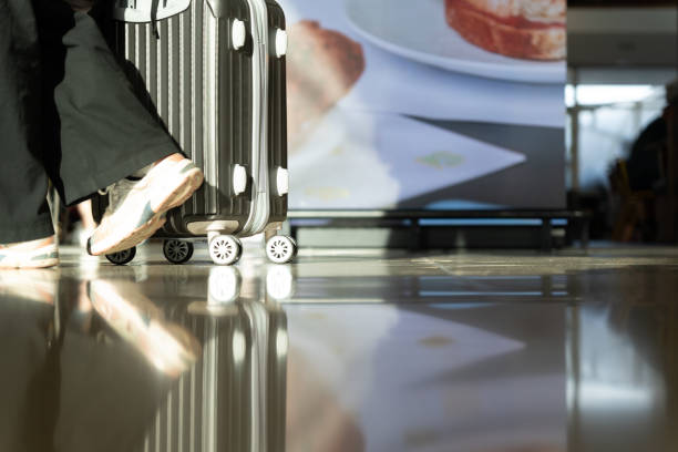 Passenger with vibrant silver suitcase excited to explore new destinations