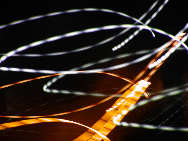 istock Light Trails Dance in Vibrant Abstraction Through a Darkened Backdrop 2191540711