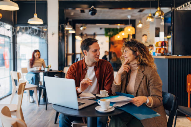 istock A man and a woman work from a coffee shop. They use a laptop while editing documents and preparing business reports 2191540786