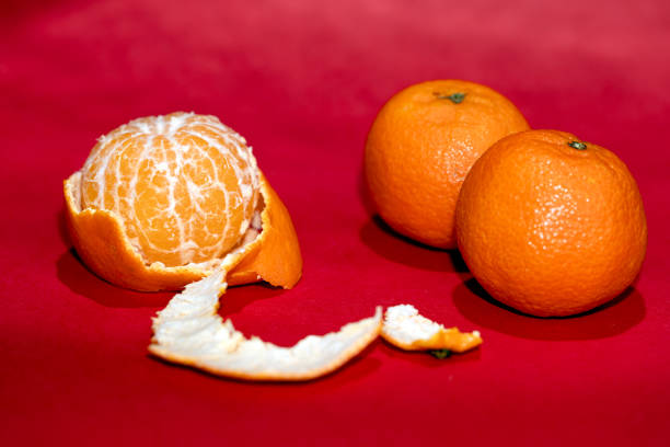 peeled mandarin on a red background, tangerines on a bright red background