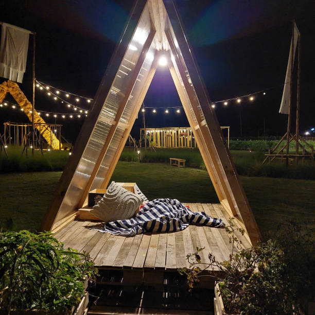 istock A wooden pavilion decorated with straw and lights at night 2191544254