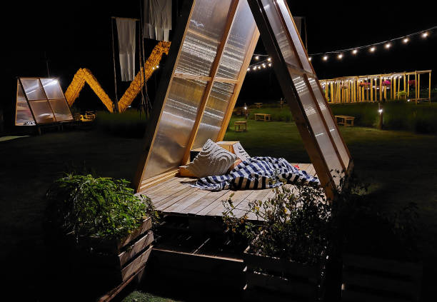 istock A wooden pavilion decorated with straw and lights at night 2191544285