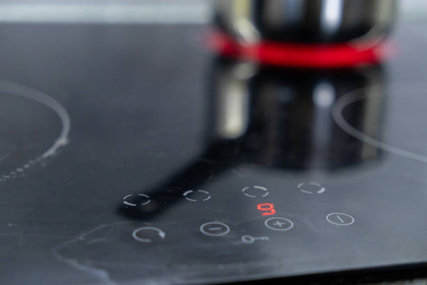 istock close-up of an induction stove control panel with red digital display and reflection of a boiling pot in the background 2191546024