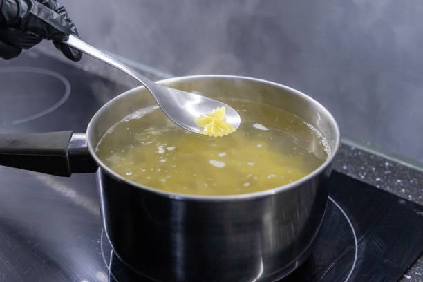 istock steaming pot with boiling farfalle pasta and spoon lifting a single piece over hot water 2191546104