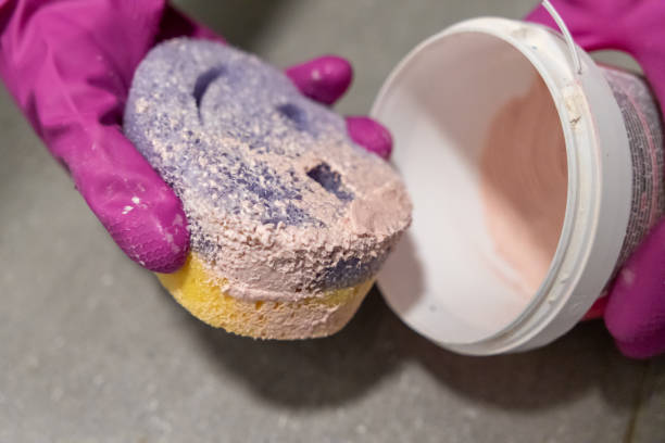 istock cleaning sponge with pink paste held by gloved hands, ready for deep surface scrubbing and stain removal 2191546198