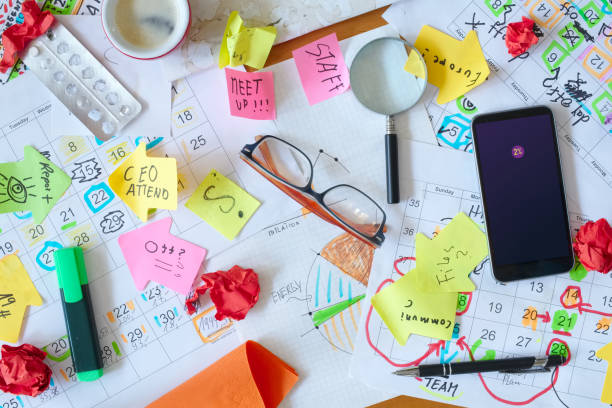 istock Calendars with business appointments and adhesive notes on cluttered desk. Business concept,beat the clock,overwoked,bureaucracy 2191547543