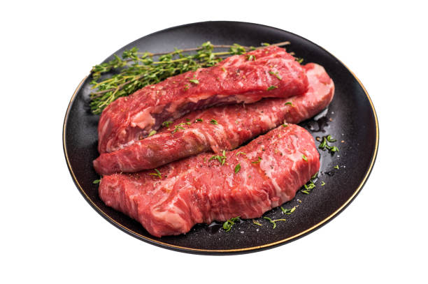 istock Tri tip steaks, Raw marbled beef meat on plate with herbs isolated on white background 2191547973