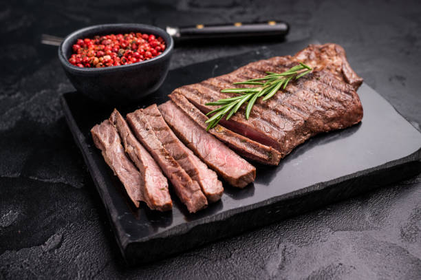 istock Grilled medium beef Rump steak on marble board. black background. top view 2191548011