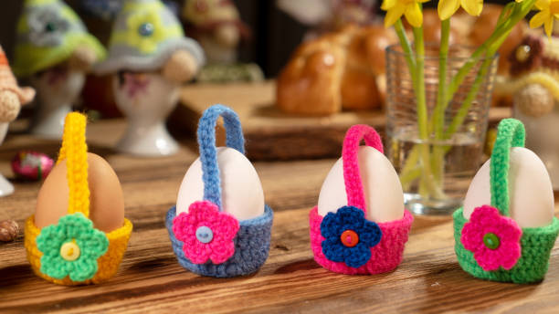 istock Four eggs in colorful crochet flower-decorated holders. 2191548781