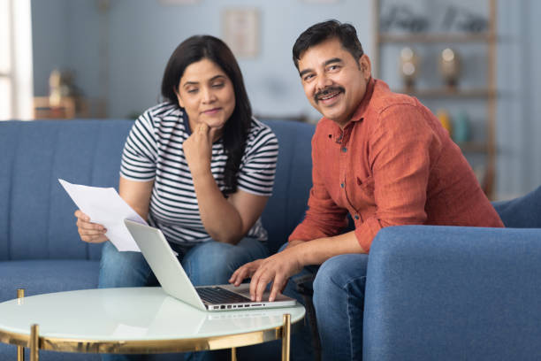 istock Happy couple checking documents with using laptop stock photo 2191550603