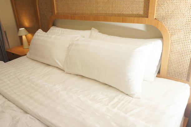 istock A Cozy, Serene Bedroom with Plush Pillows and Warm Lighting 2191551135