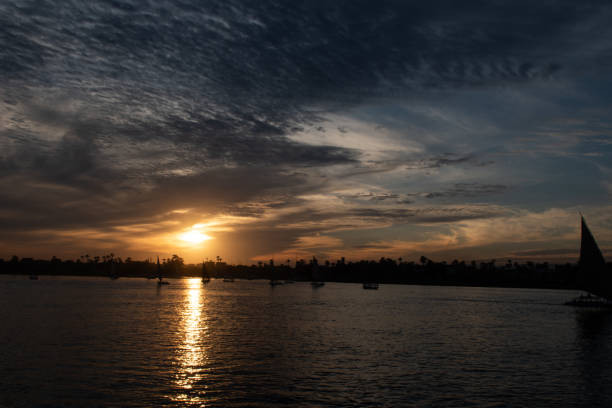 Beautiful sunset with dramatic clouds over the river Nile in Luxor, Egypt.