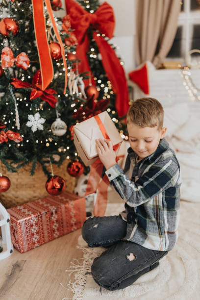 istock Curious boy tries to guess what's inside the gift 2191553581