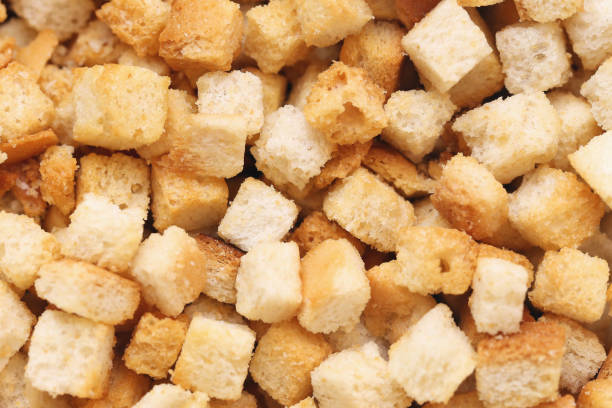 istock Crispy bread croutons for soup. Golden fried bread cubes texture. Tasty and crunchy appetizer. Perfect addition for soups and salads. 2191553711