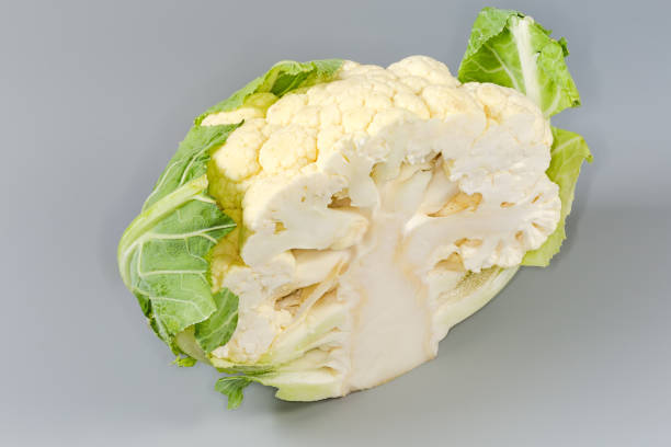 istock Half of raw cauliflower head on a gray background 2191555818