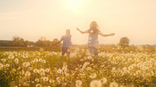 istock Playful Children Dancing Through Dandelion Field Under Warm Evening Light 2191560433