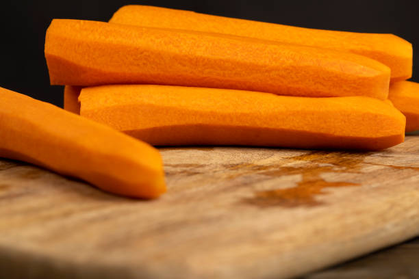 closeup carrots on the table during cooking, sweet ripe orange carrots peeled and washed