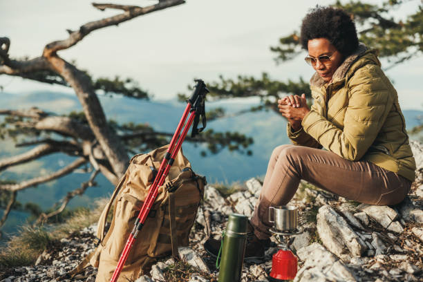 istock Woman Preparing Tea While Hiking On Mountain 2191568337