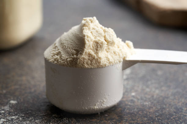istock Whey protein powder in a plastic measuring scoop, closeup 2191570441