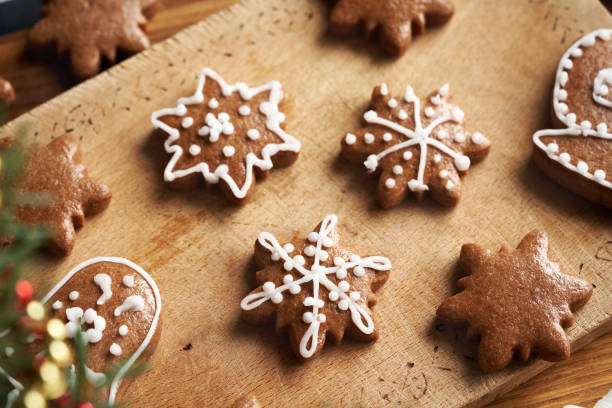 istock Decorating star shaped homemade gingerbread Christmas cookies with white icing 2191571995