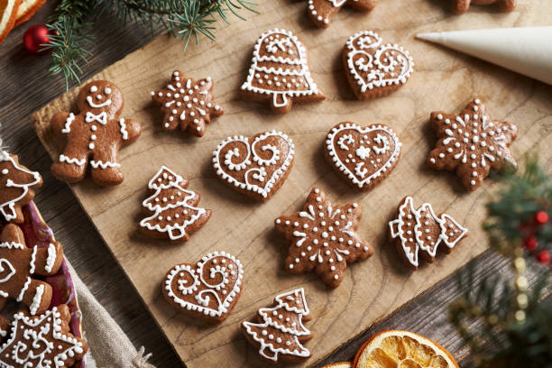 istock Decorating homemade gingerbread Christmas cookies with white icing 2191572019