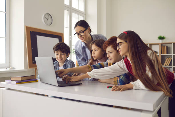 istock Pupil pointing at laptop screen discussing with teacher media material on lesson 2191574565
