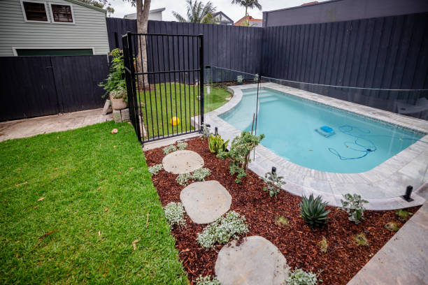 istock Private backyard pool with landscaped garden patio 2191575568