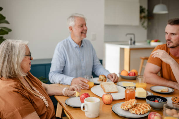 istock Senior couple converses over tasty breakfast spread 2191575685