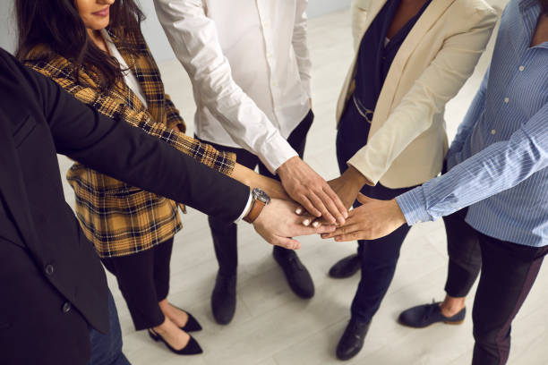 istock Multiethnic business team hands together stacking in circle midsection shot 2191575727